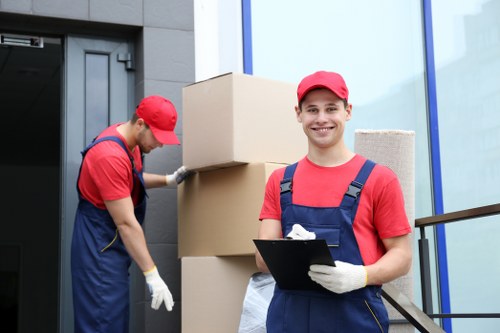 Mover wearing PPE while handling boxes on a relocation job